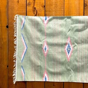 Vintage inspired green blue and pink southwestern fridge rug.